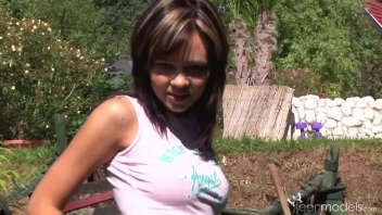 Nikita shows off her breasts in the garden